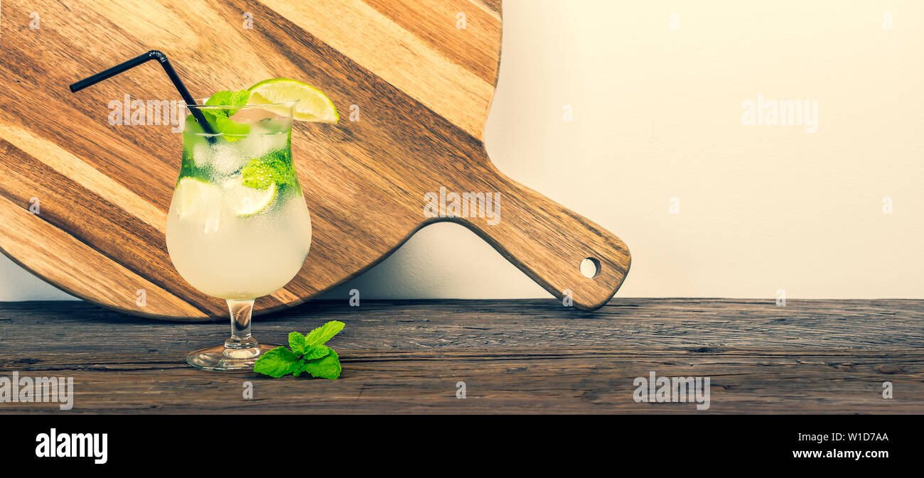 Refreshing tropical mint lemonade in a glass on a rustic table. Summer cocktail. Stock Photo