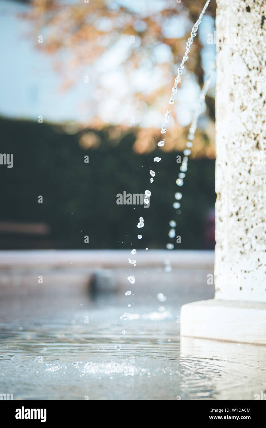 Fresh water drops falling into a well, summer time Stock Photo - Alamy