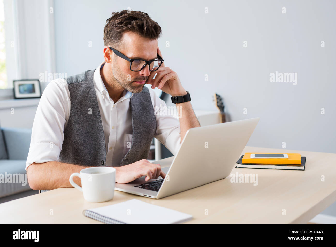 Designer working on laptop from home - freelance concept Stock Photo