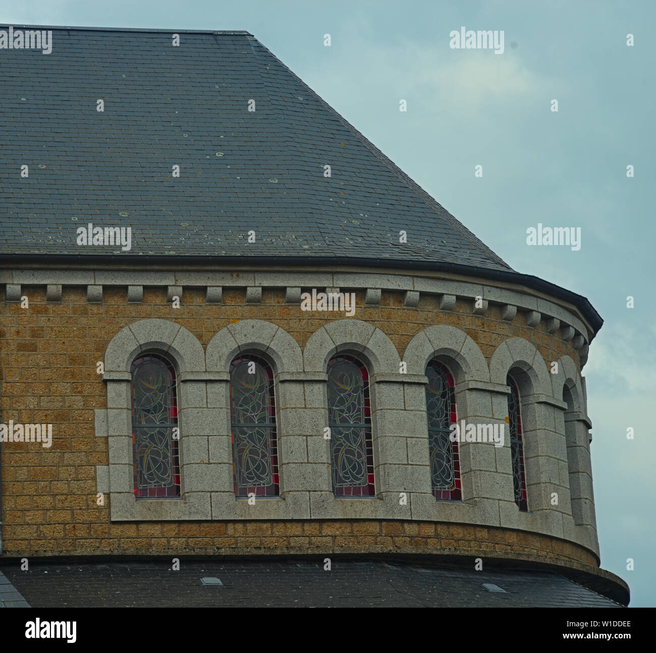 Part of catholic church with rooftop and many windows Stock Photo