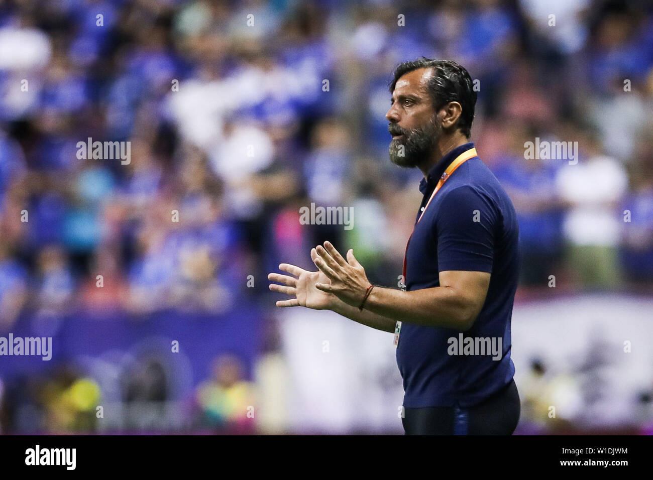 Head coach Quique Sanchez Flores of Shanghai Greenland Shenhua reacts as he watches his players competing against Guangzhou Evergrande Taobao in their 15th round match during the 2019 Chinese Football Association Super League (CSL) in Shanghai, China, 1 July 2019. Guangzhou Evergrande Taobao defeated Shanghai Greenland Shenhua 3-0. Stock Photo