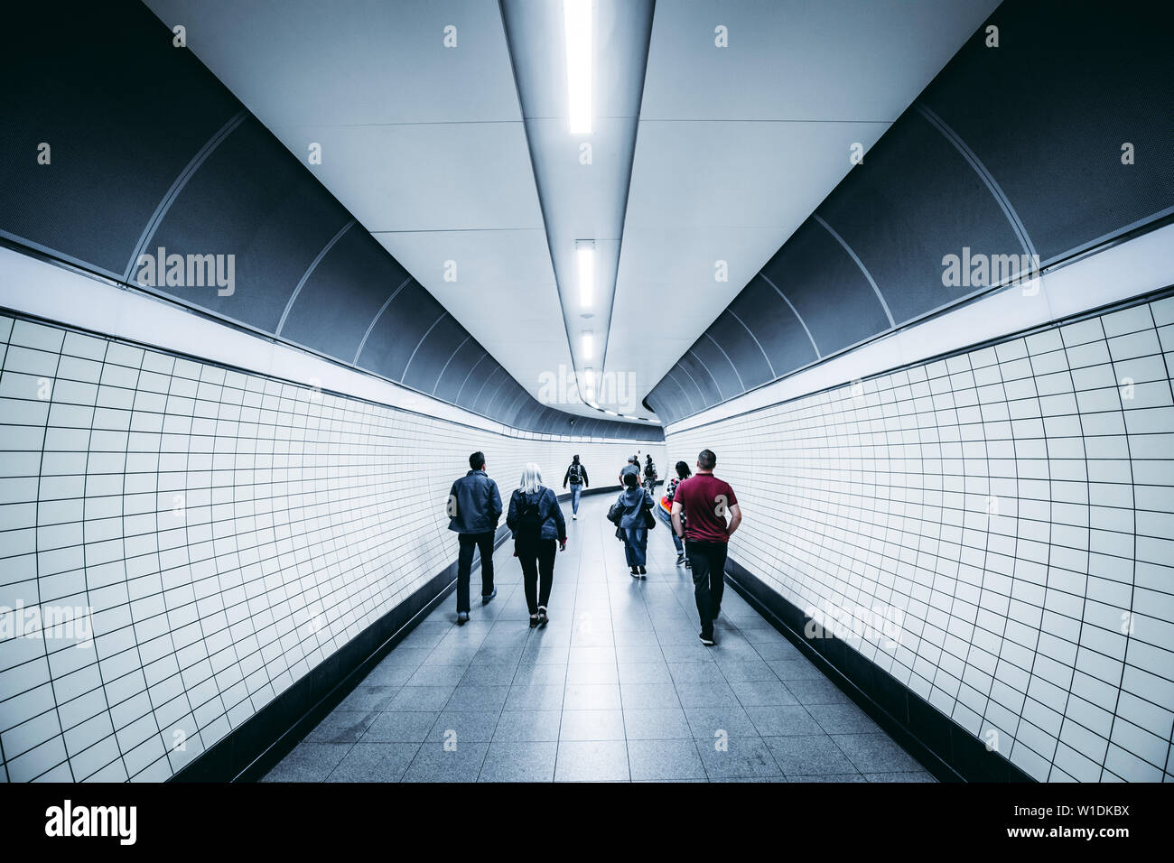 LONDON - JUNE 26, 2019: People walking in modern city tunnel on London Underground crossrail tube train station Stock Photo