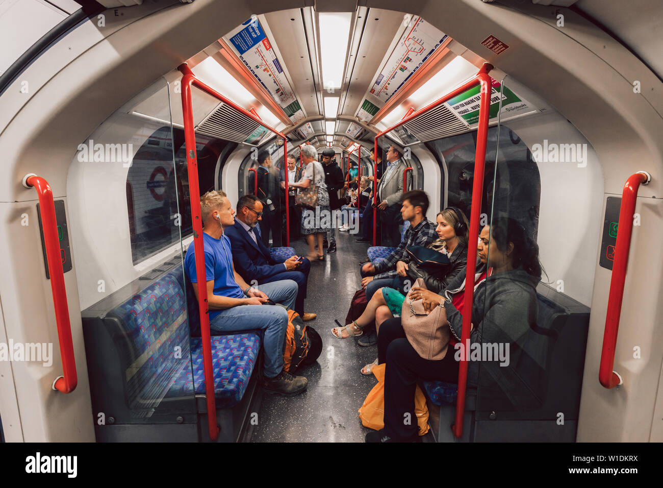 LONDON - JUNE 26, 2019: People sitting in tube train on London ...