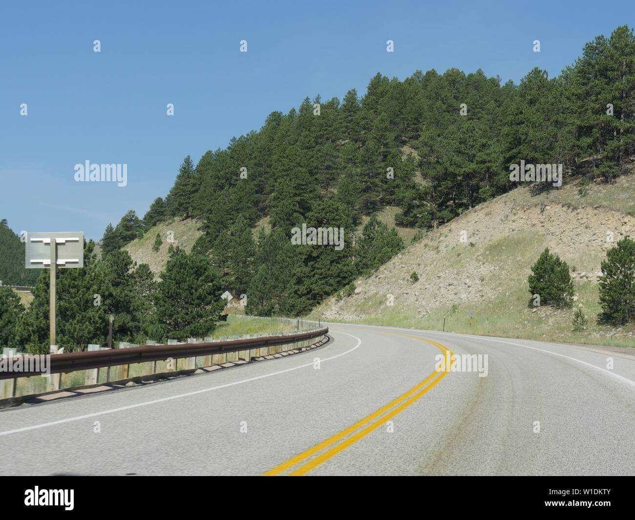 Medium wide shot of along a scenic winding road at Interstate 90 in Wyoming Stock Photo - Alamy