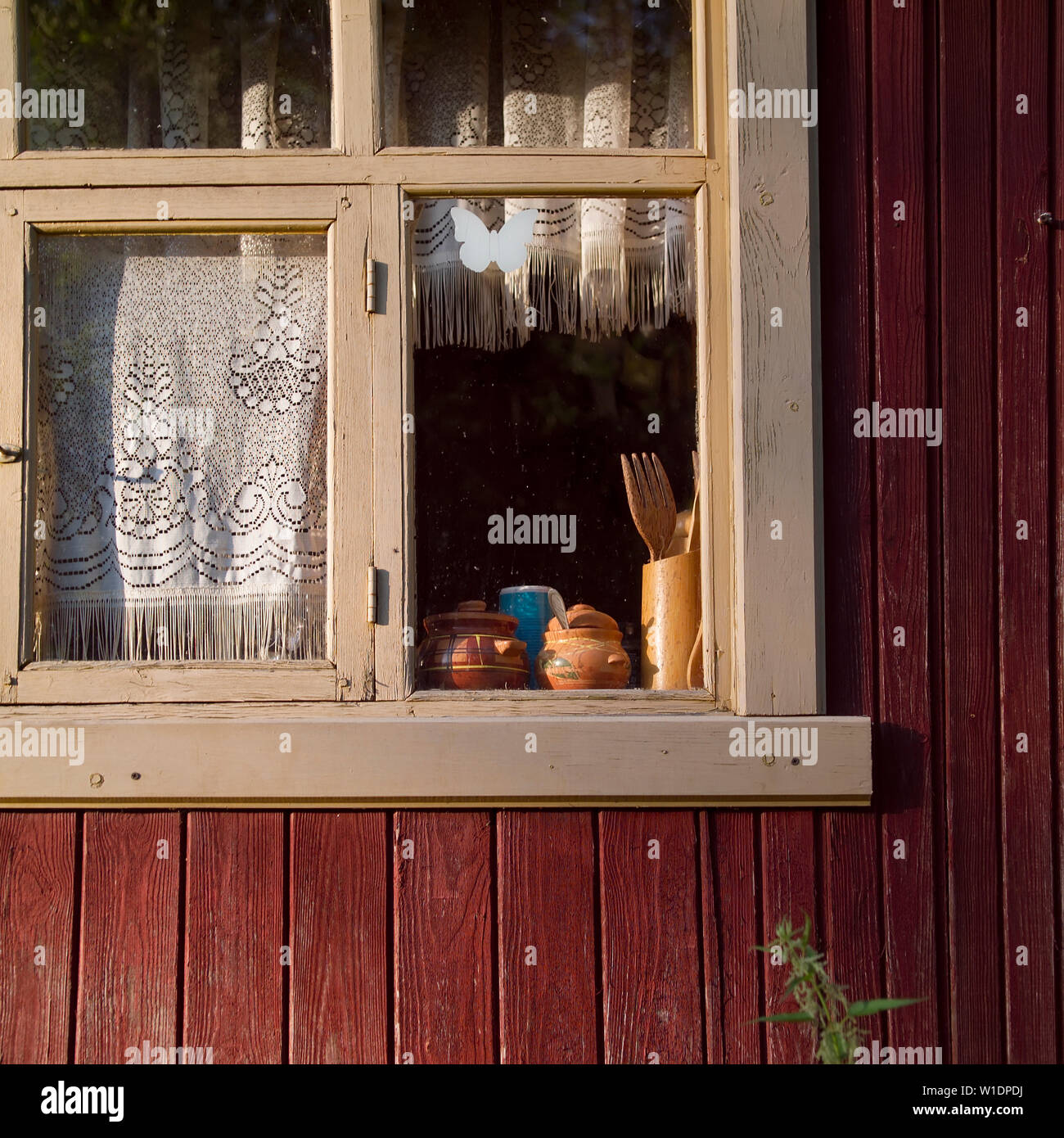 Old countryside house with kitchenware behind the window, square ...