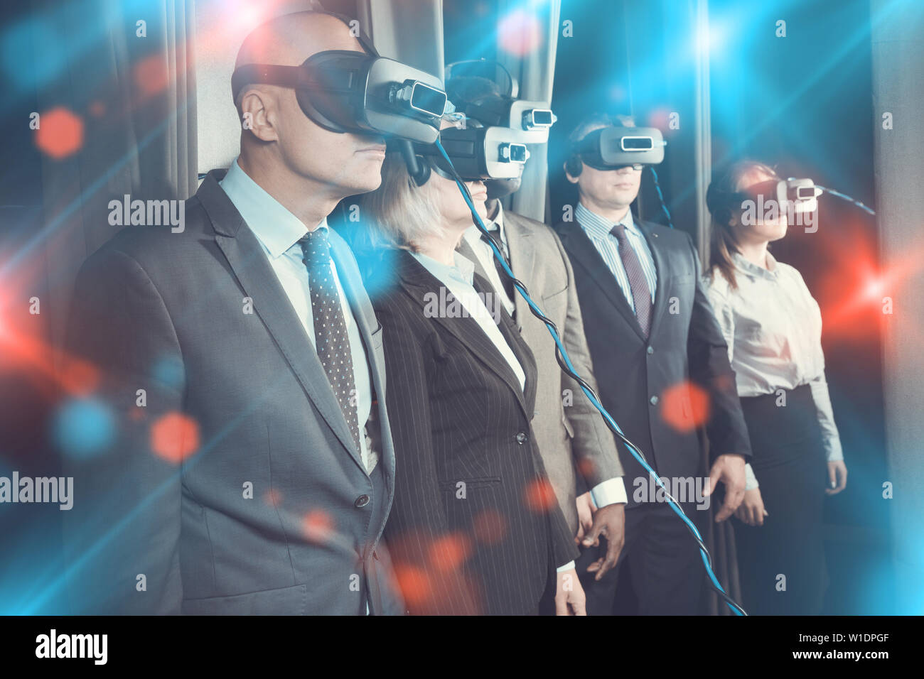 Unemotional business people wearing virtual reality headset with glow effect. Concept of illusion of finding solutions Stock Photo