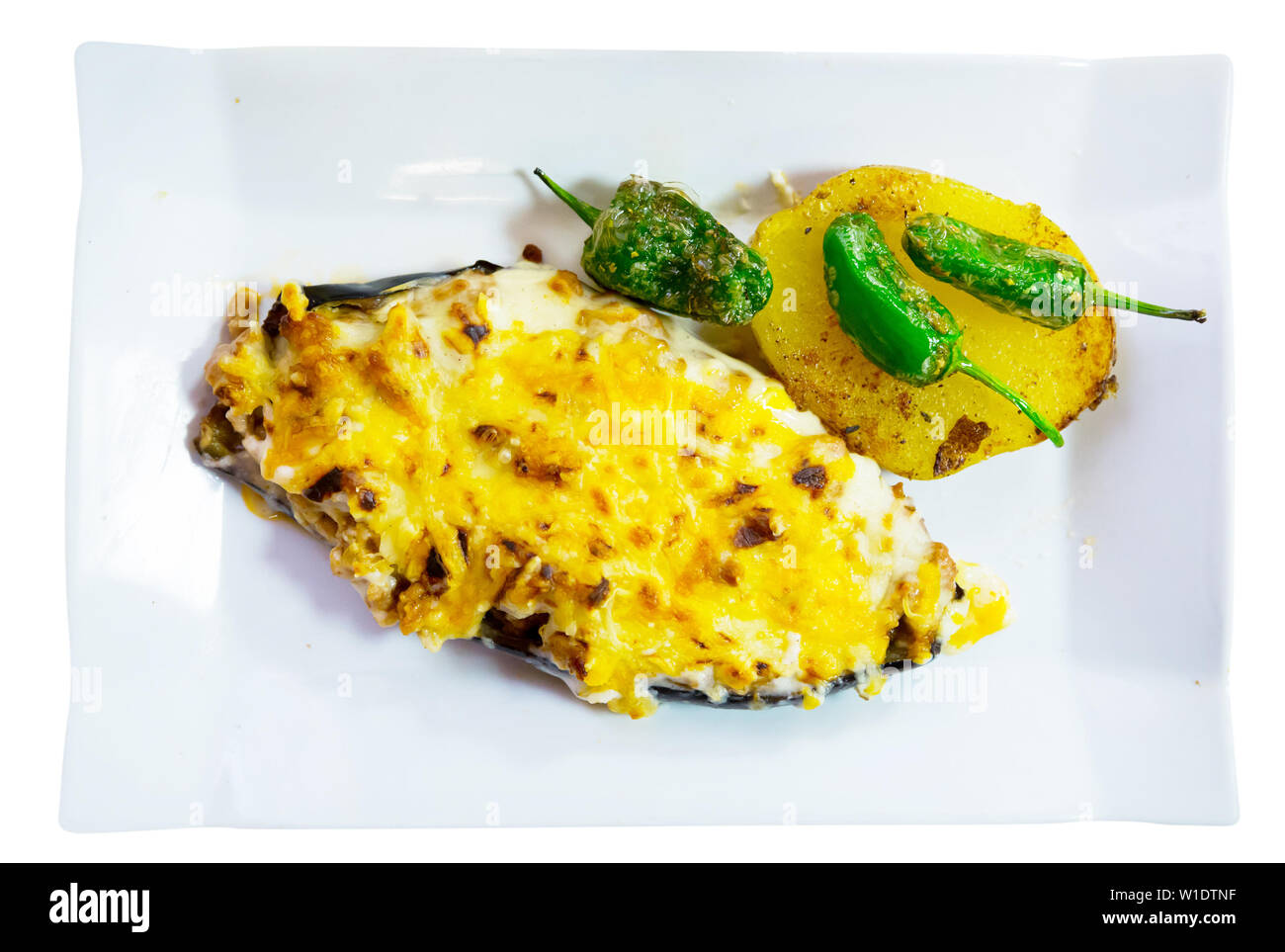 Stuffed with meat tasty eggplant baked with bechamel sauce and cheese. Isolated over white background Stock Photo