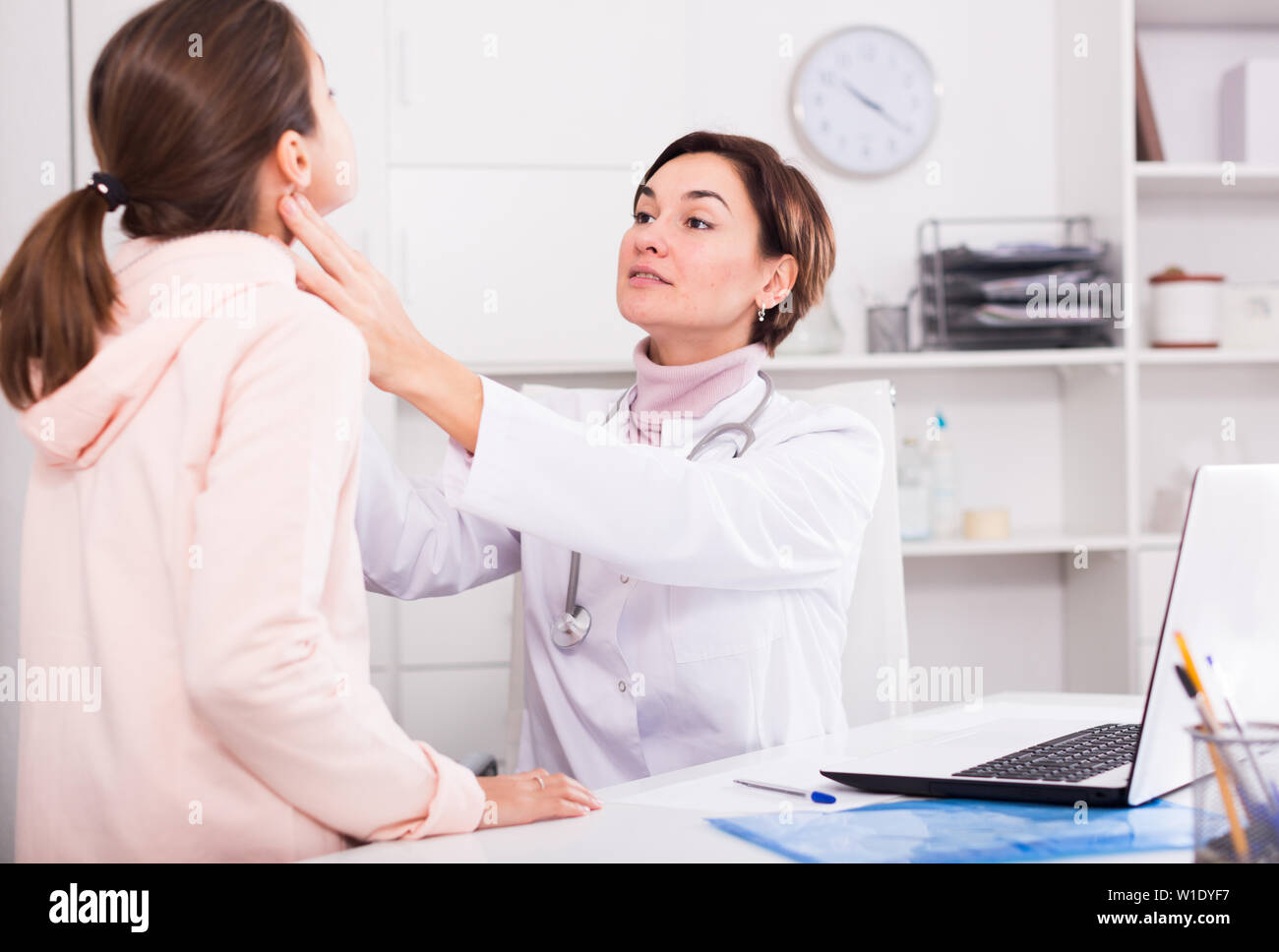 Teenage girl visits doctor in hospital for survey and check of your