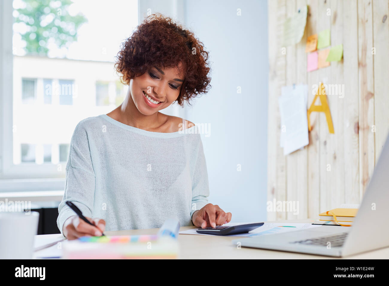 Positive black woman working hi-res stock photography and images - Alamy