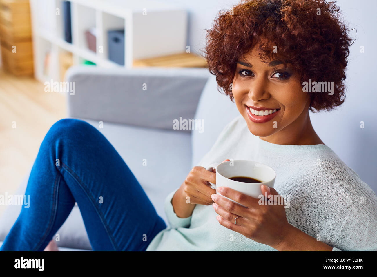 Relaxed curly african woman in hi-res stock photography and images - Alamy