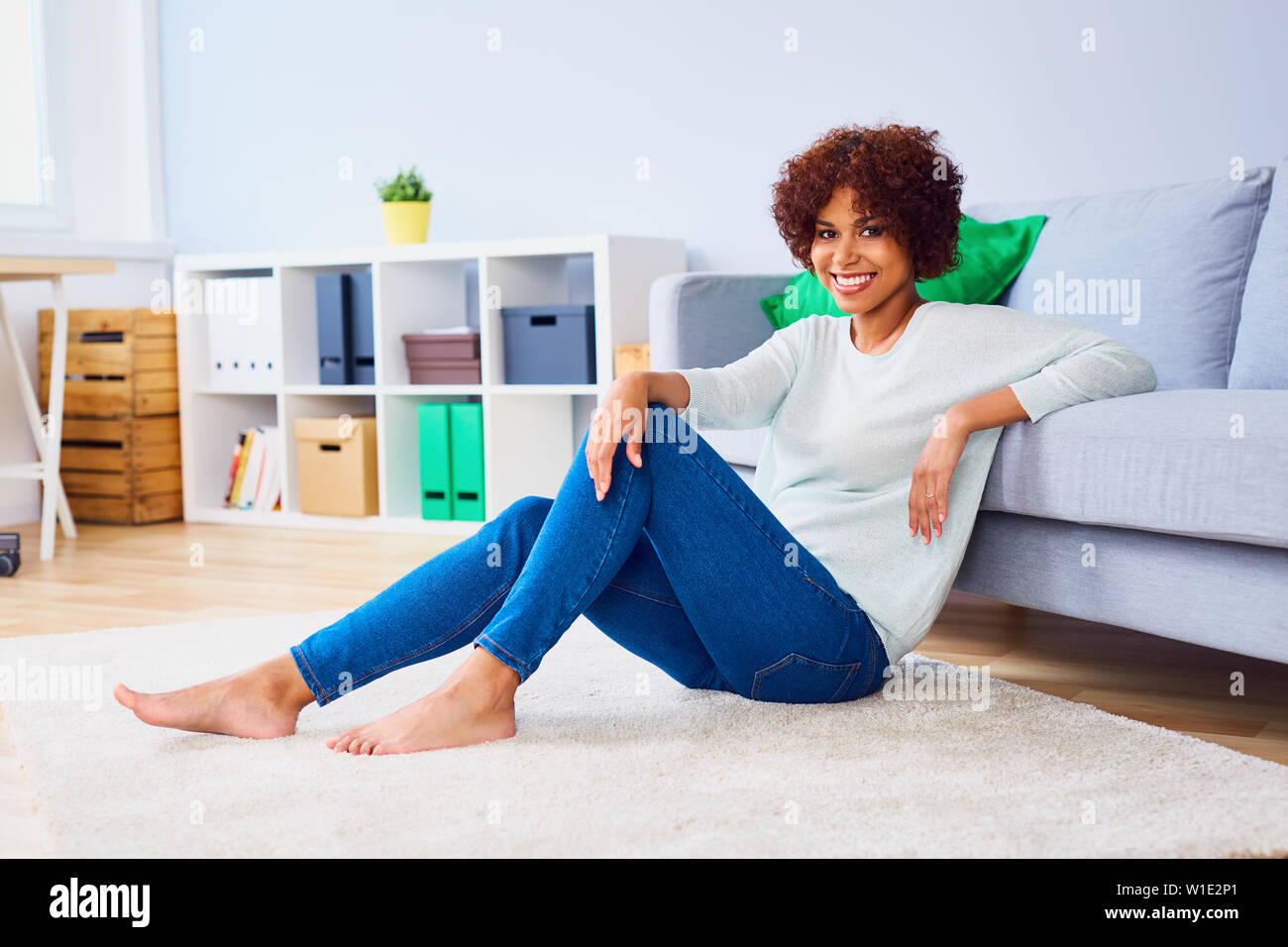 African woman sitting hi-res stock photography and images - Alamy