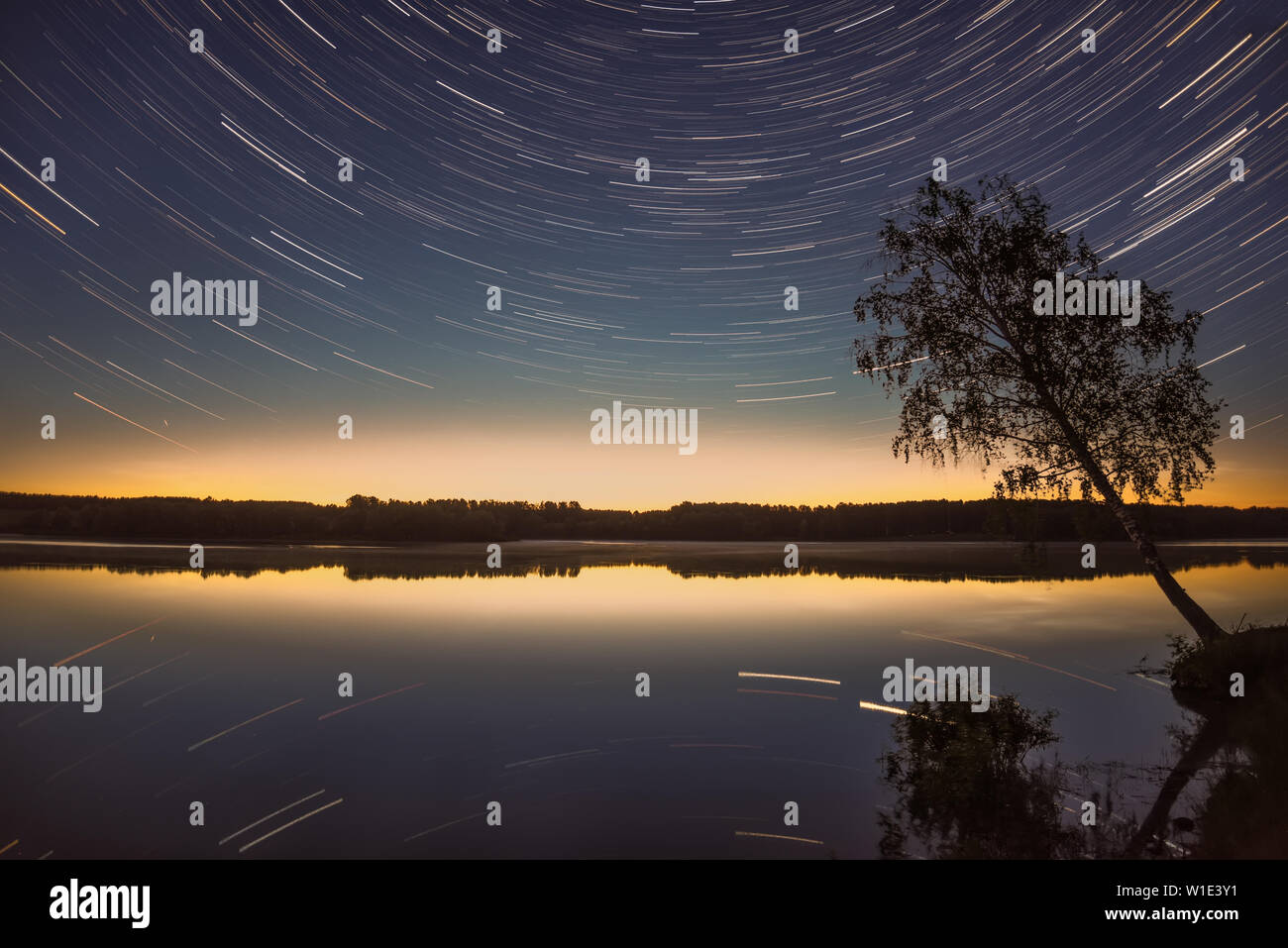 Amazing view of the night sky with stars in the form of tracks over the ...