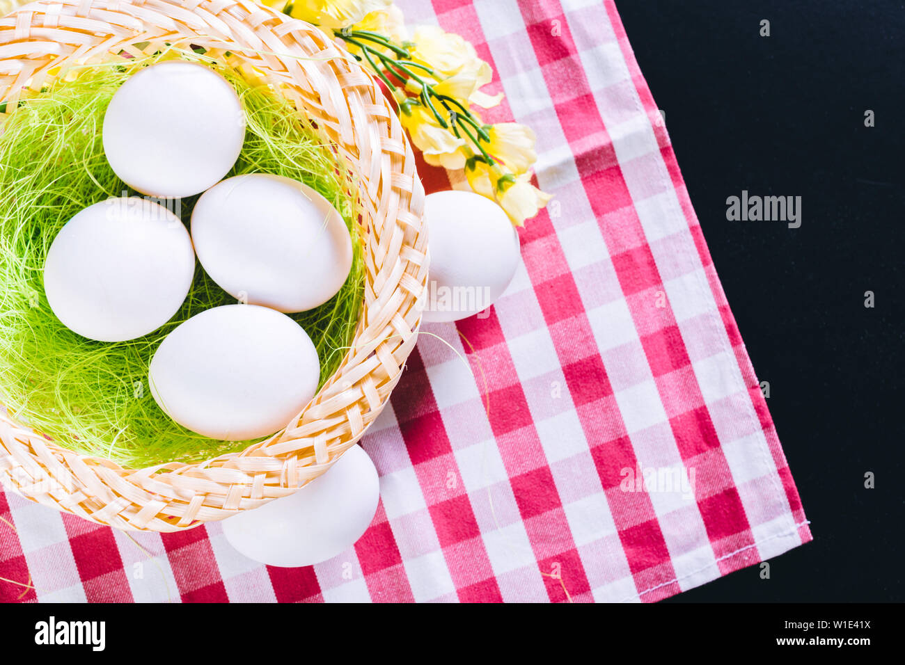 Eggs on tablecloth over black background Stock Photo