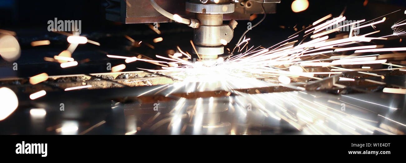 Sparks fly out machine head for metal processing Stock Photo