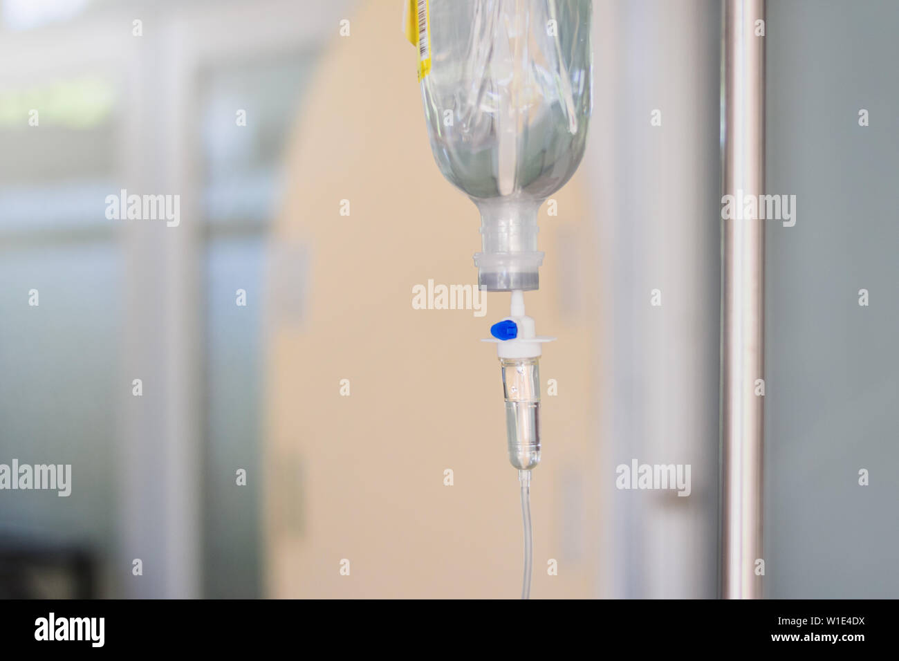 Intravenous therapy iv infusion set and bottle on a pole. Liquid saline is slowly dripping drops of drugs, medicine or antibiotic therapy and surgery Stock Photo