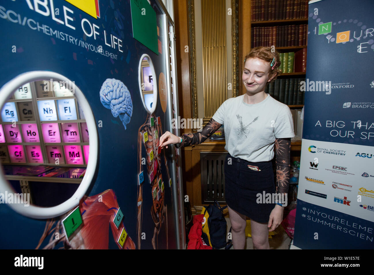 Royal Society Summer Science Exhibition, young woman placing elements