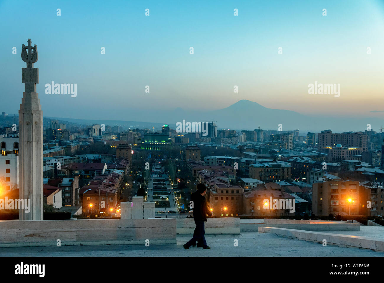 Locals watching the sunset and Mount Ararat the top of the Cascade with Yerevan city in the background Stock Photo