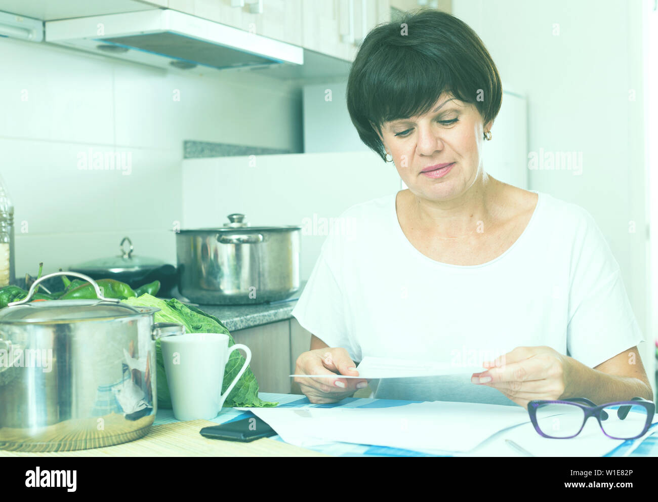 Mature woman paperwork thinking hi-res stock photography and images - Alamy