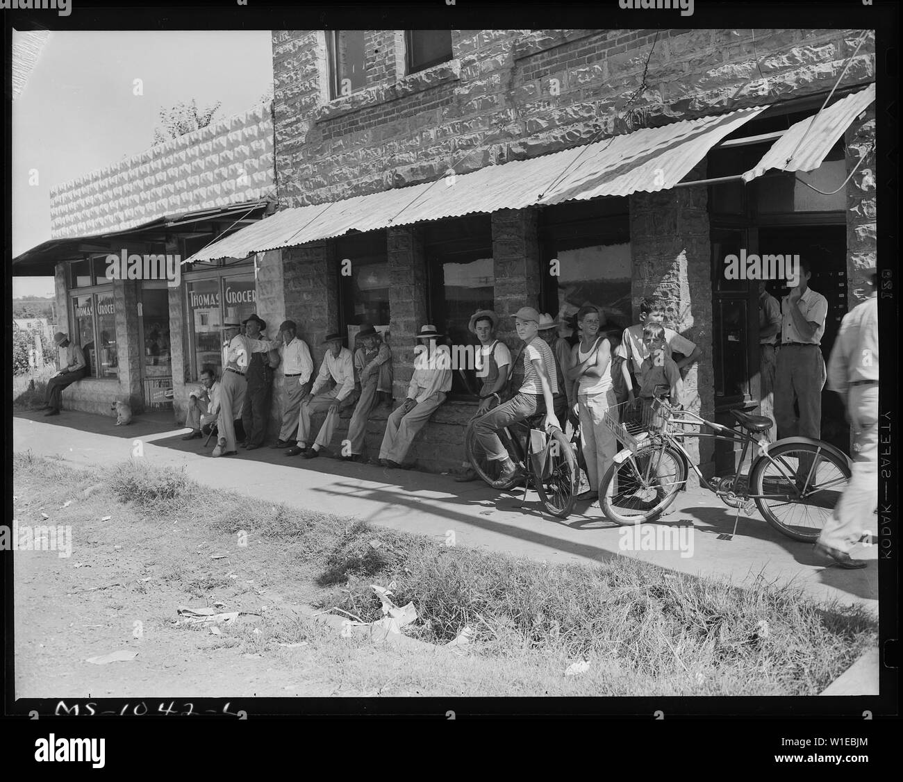 Group of men and boys in front of the post office waiting for the mail. Bokoshe, Le Flore County, Oklahoma. Stock Photo