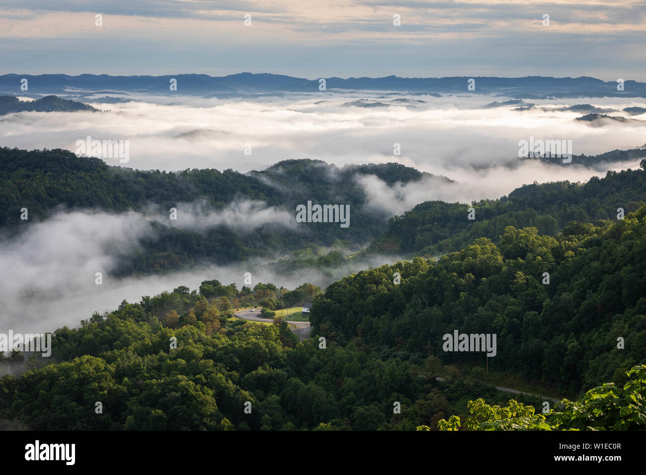 The morning fog hovers above the distant mountains in the scene from Central Appalachia. Stock Photo