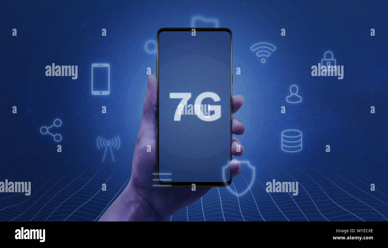 7G network abstract concept. Smart phone in woman hand with 7G text on the screen surrounded by service icons. Stock Photo