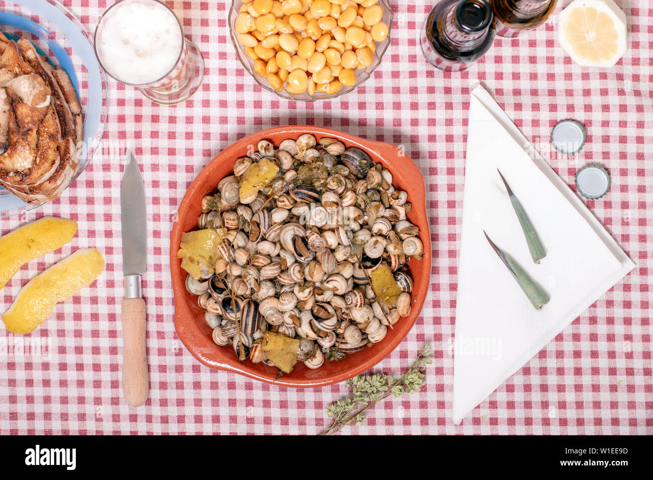Traditional Portuguese dish of cooked snails and toasted bread and beer