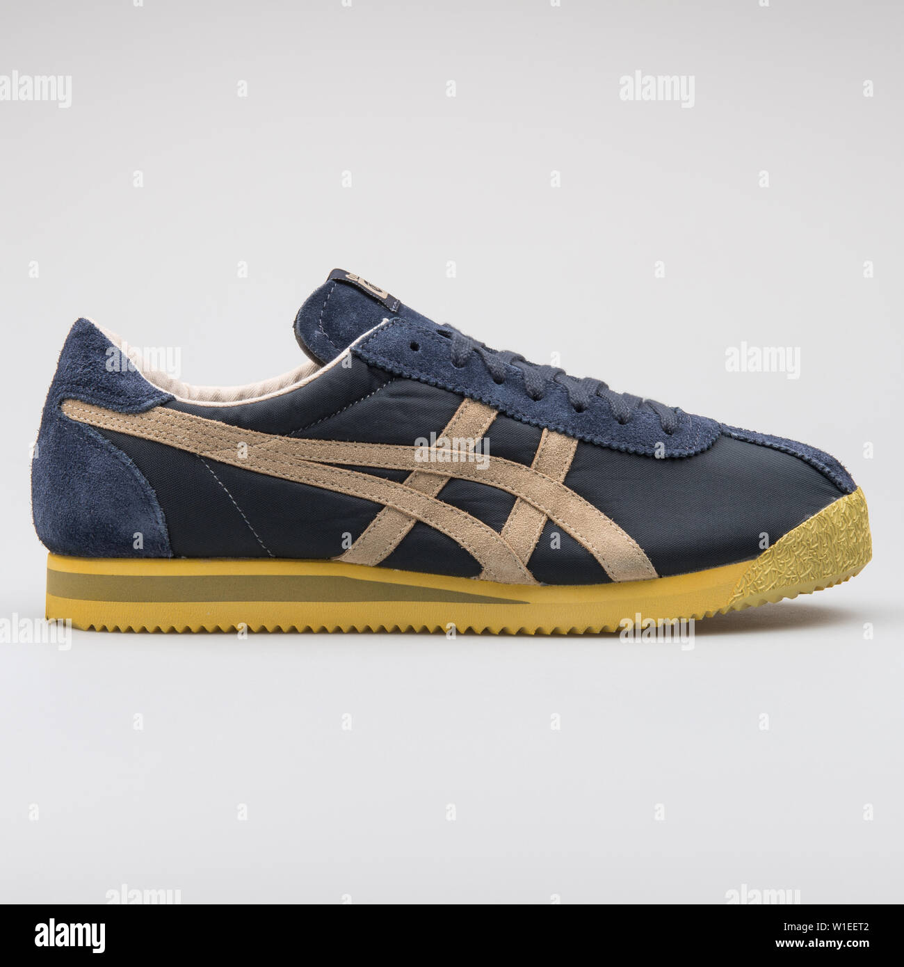 bancarrota Empuje ambiente VIENNA, AUSTRIA - AUGUST 7, 2017: Onitsuka Tiger Corsair VIN blue and  yellow sneaker on white background Stock Photo - Alamy