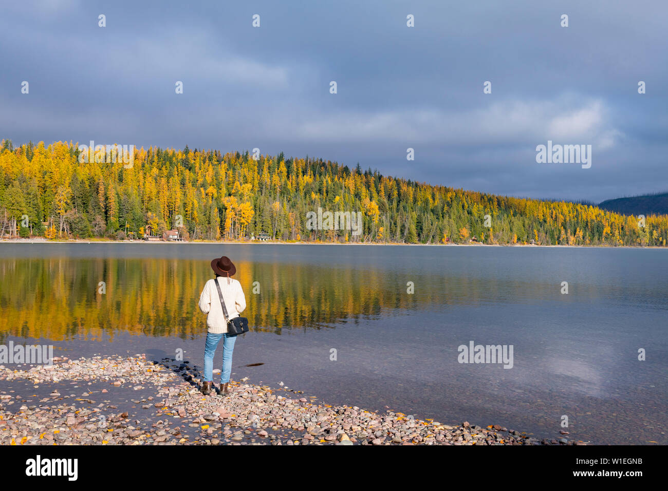 Woman on the shore of Lake McDonald, Glacier National Park, Montana, United States of America, North America Stock Photo