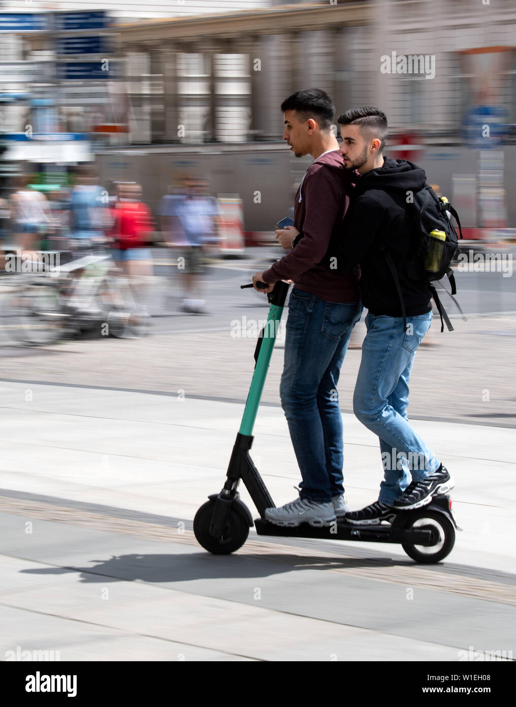 02 July 2019, Berlin: Two tourists from Wuppertal (NRW) drive on an  electric scooter through Berlin-Mitte. After the new electric pedal  scooters were allowed, the Berlin police have already established a whole