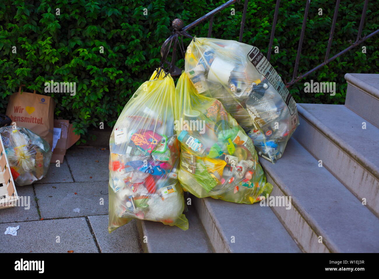 Yellow bags for plastic waste, hanging on a banister, hanging, Bremen, Germany, Europe I Gelbe Säcke für Plastikmüll, an eimem Treppengeländer,  hänge Stock Photo