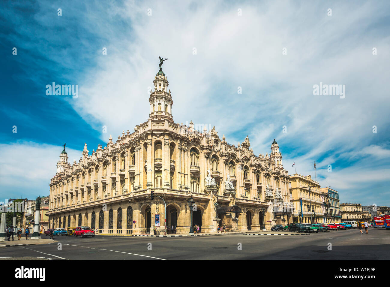 Old American cars drive past the Gran Teatro de La Habana in La Habana (Havana), Cuba, West Indies, Caribbean, Central America Stock Photo