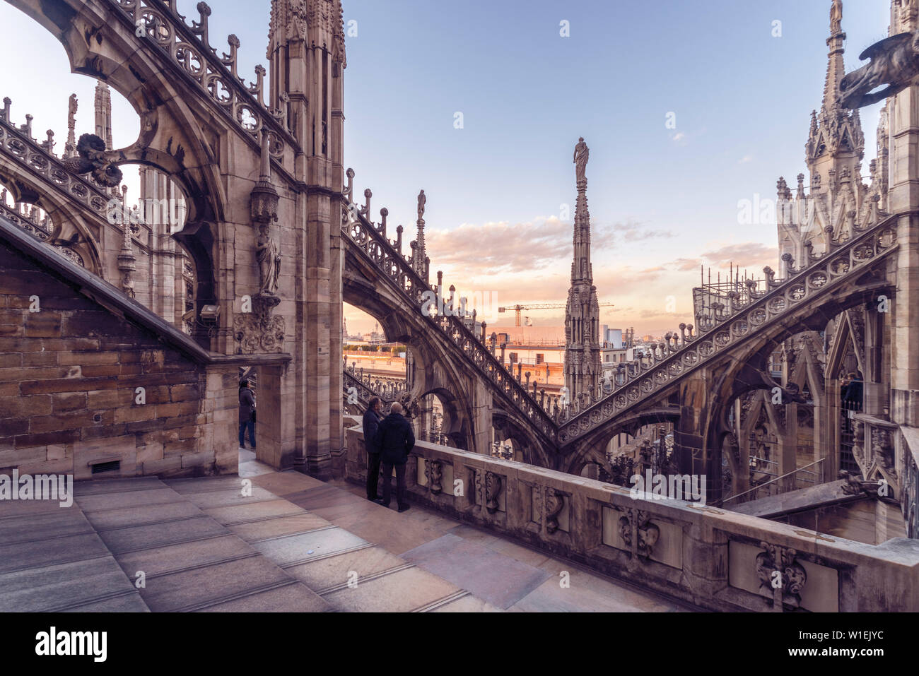 The sunset lingers over the Duomo di Milano, the second largest
