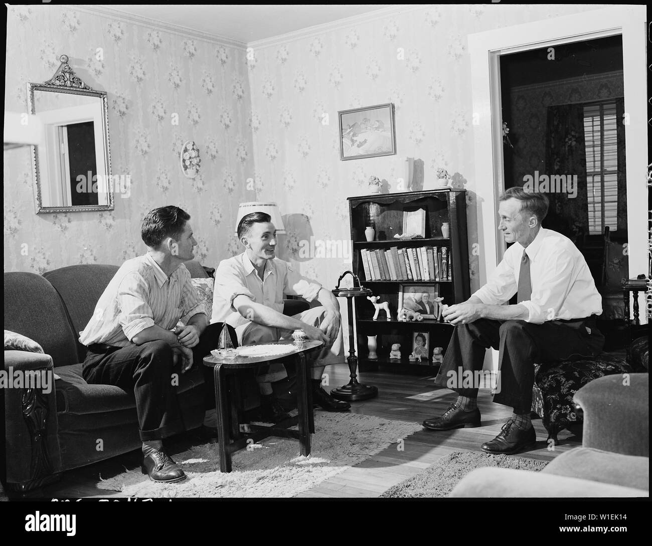 Harry Fain, coal loader, (right) talks to some visiting friends on ...