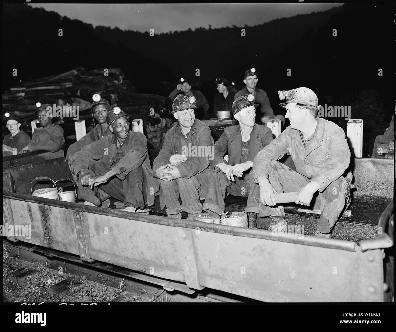 Harry Fain, second from right, seated in shuttle car on mantrip before ...