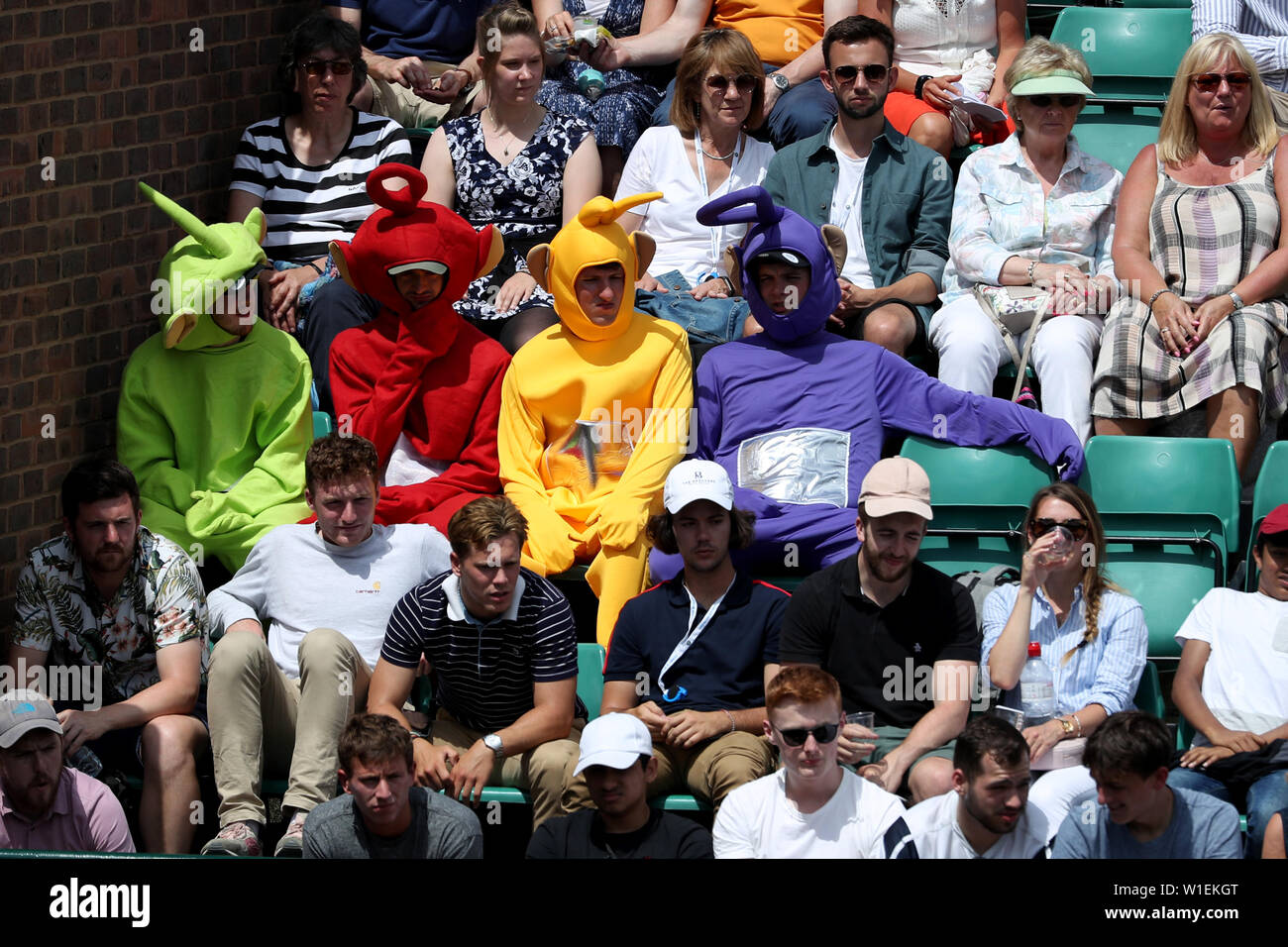 London, UK. 2nd July 2019. 2nd July 2019, The All England Lawn Tennis and Croquet Club, Wimbledon, England, Wimbledon Tennis Tournament, Day 2; Fans dressed up as the teletubbies watch Daniel Evans (GBR) versus Federico Delbonis (ARG) Credit: Action Plus Sports Images/Alamy Live News Stock Photo