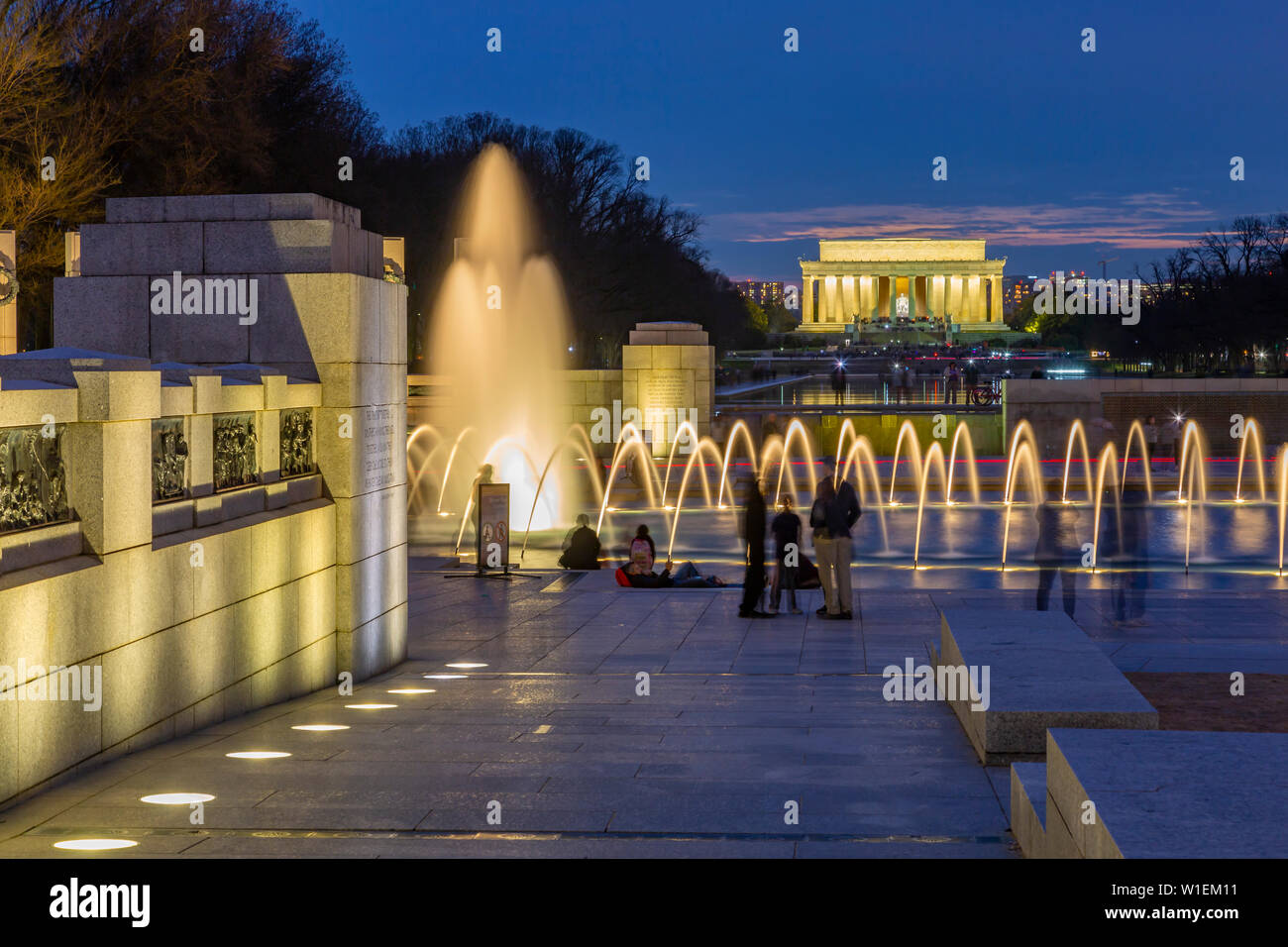 View of the World War Two Memorial and Lincoln Memorial illuminated at dusk, Washington, D.C., United States of America, North America Stock Photo