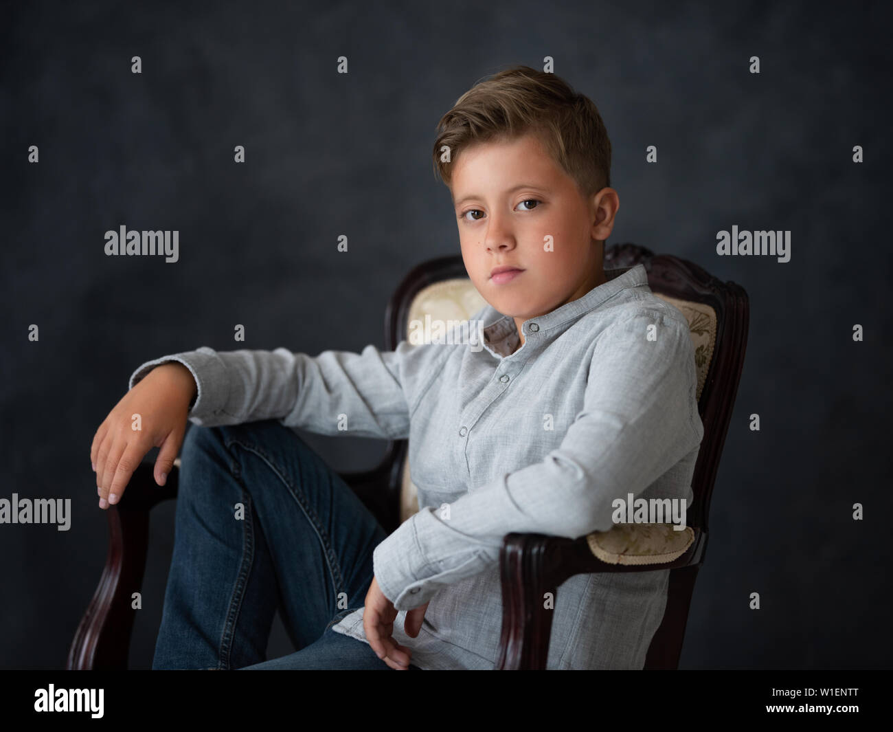 Beautiful little boy on a dark background Stock Photo