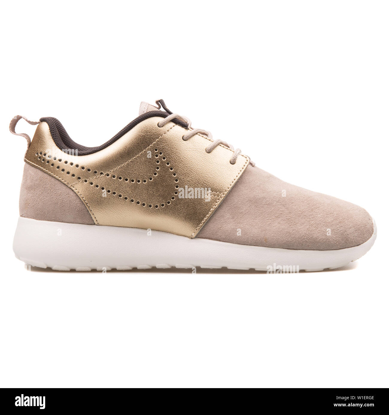 VIENNA, AUSTRIA - AUGUST 10, 2017: Nike Roshe One Premium Suede beige and  gold sneaker on white background Stock Photo - Alamy