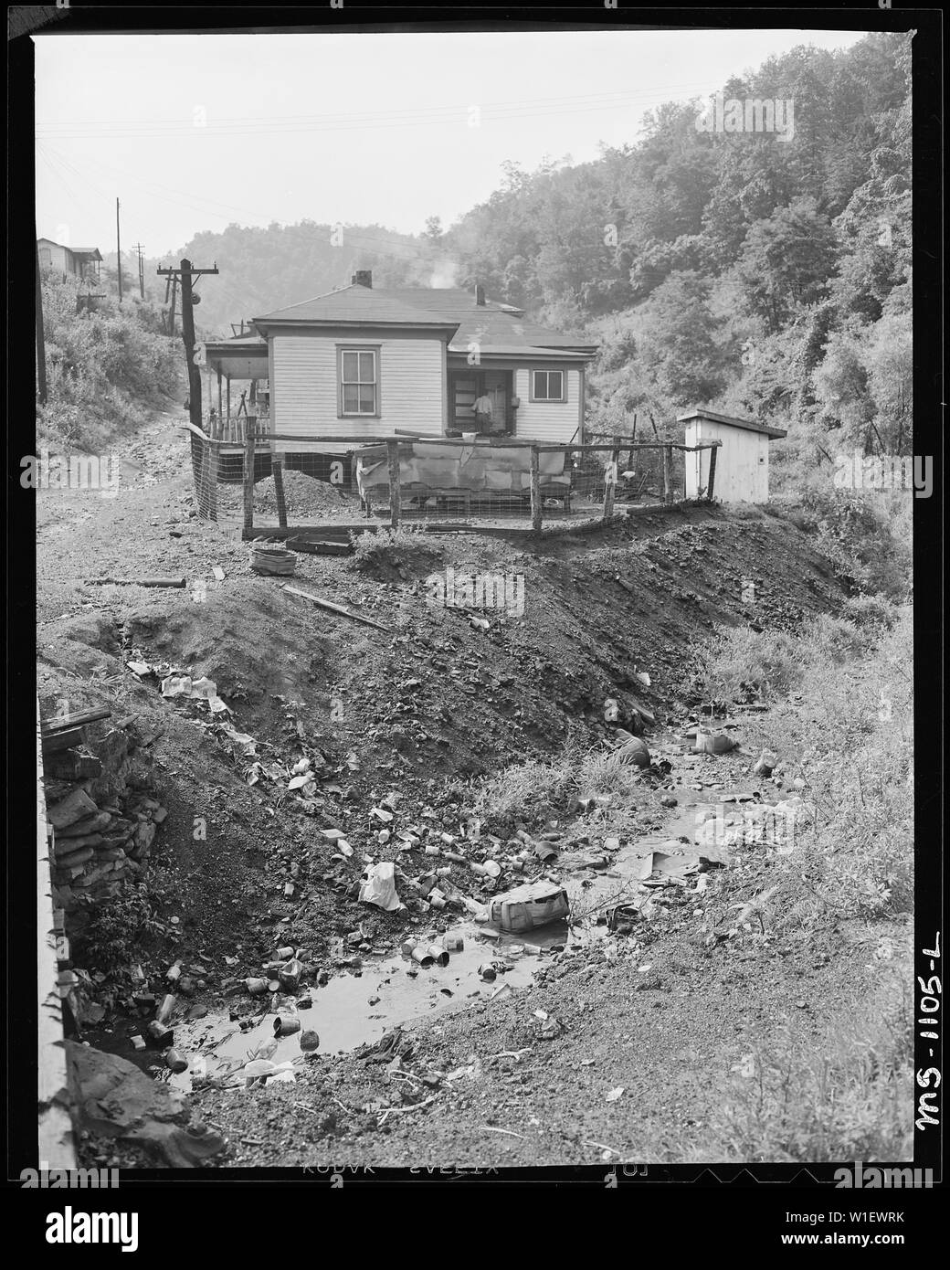 Home of miner who lives in company housing project. Note garbage