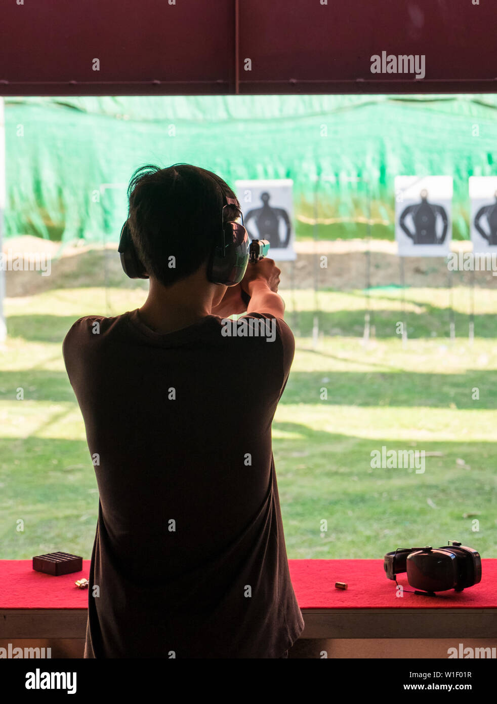 Man practice shooting pistol in shooting gallery Stock Photo Alamy