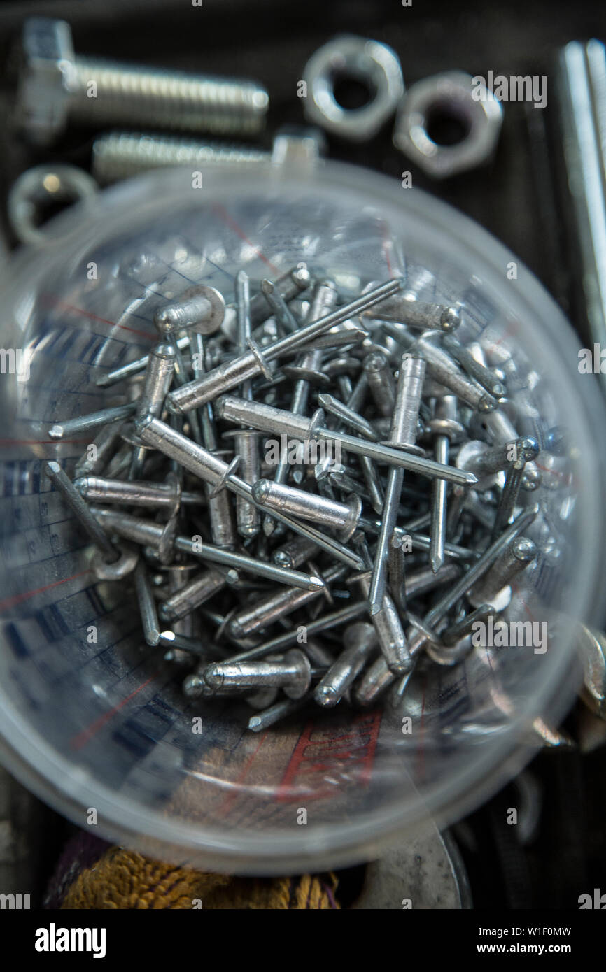 Nuts and bolts in container Stock Photo Alamy