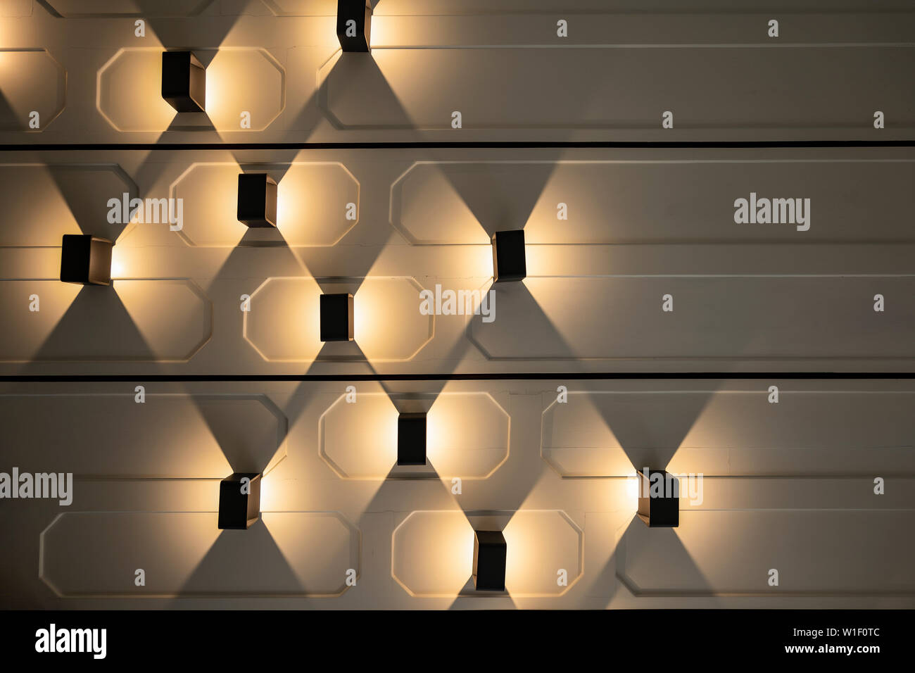 Vertical Lamp settle on the horizontal wall with Tungsten light beside it. Stock Photo