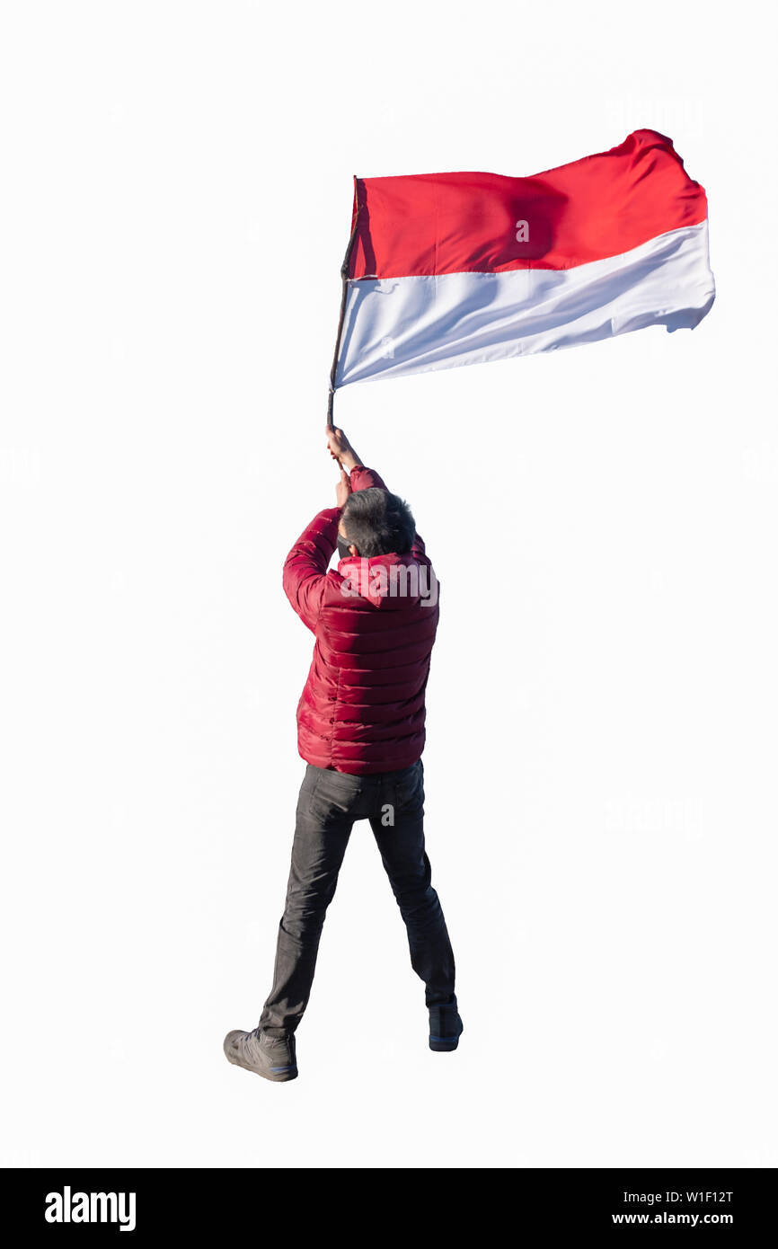 Young man wearing red coat with holding flag indonesia national. isolated on white background Stock Photo