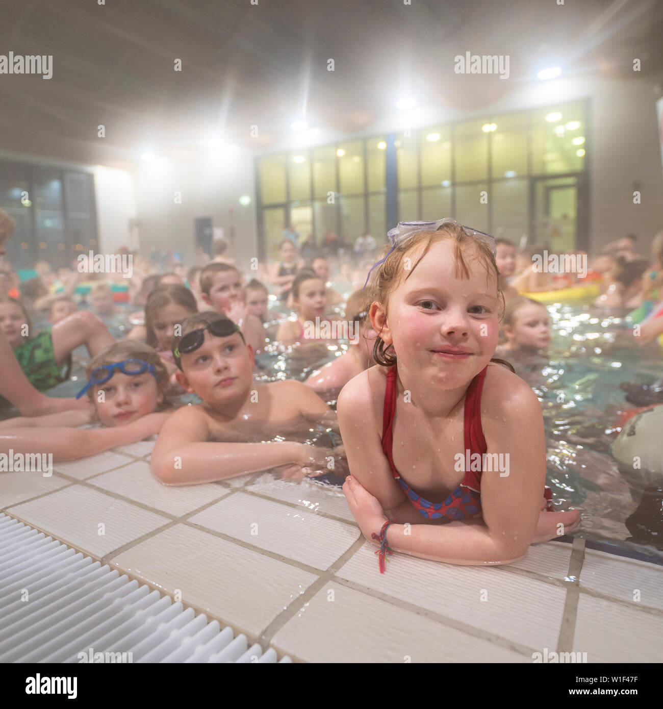 Children swimming at a local indoor pool, Kopavogur, Iceland Stock Photo