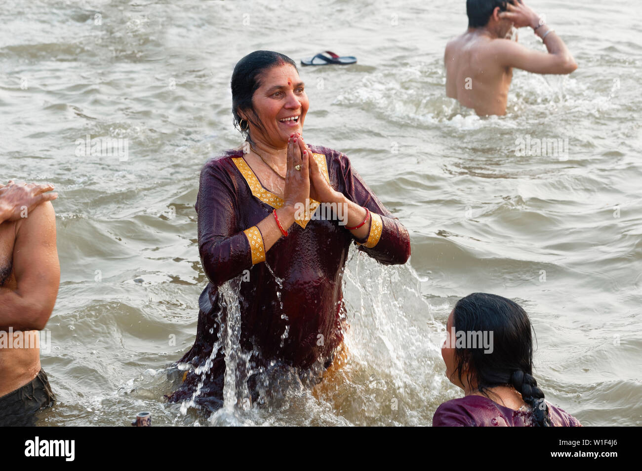 Woman bathing in the Ganges river, Allahabad Kumbh Mela, World’s largest religious gathering, Uttar Pradesh, India Stock Photo