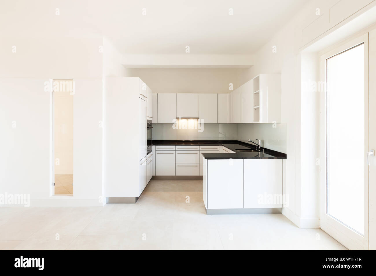 Wide white kitchen in a modern apartment Stock Photo