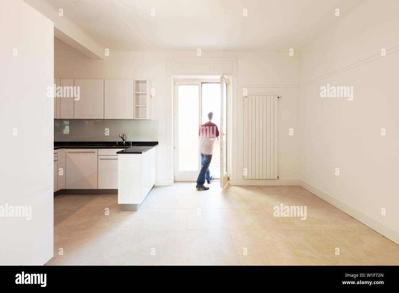 Man standing in the window kitchen Stock Photo