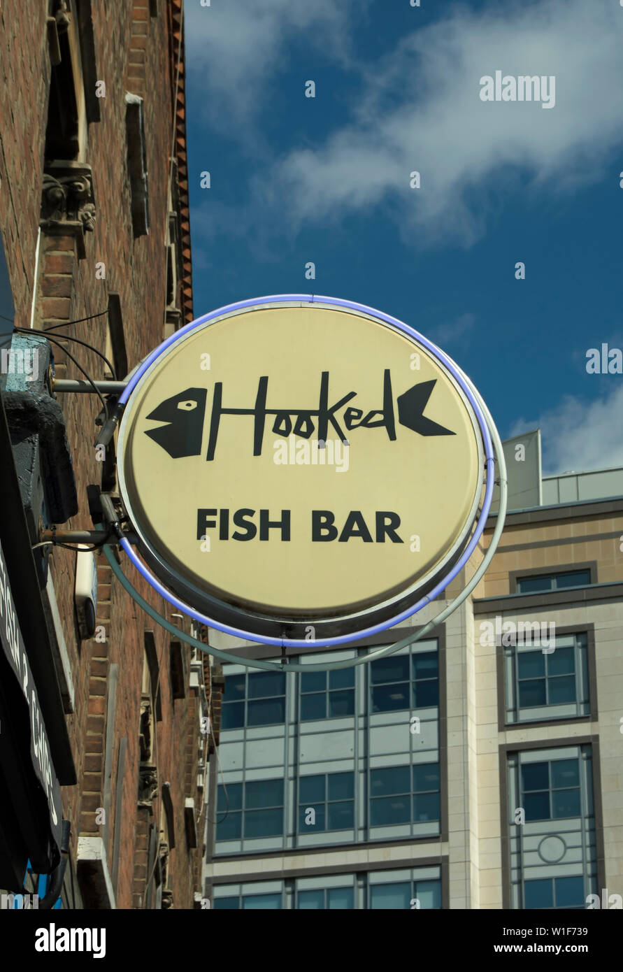 hanging sign for hooked fish bar, hammersmith, london, england, using a fish skeleton image Stock Photo