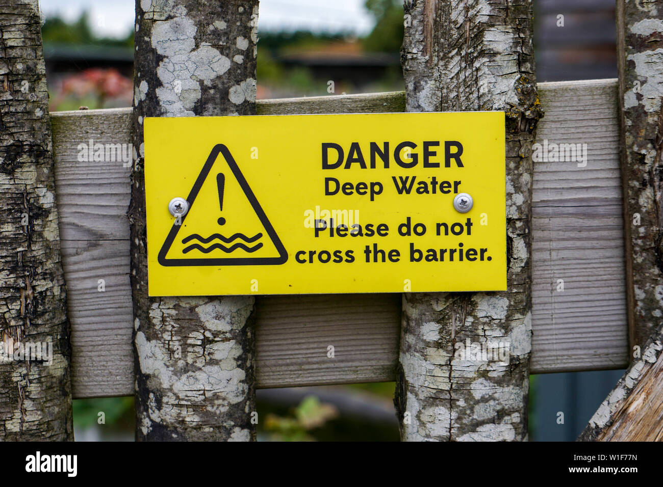 DANGER: Deep water.- please do not cross the barrier. Taken at Twycross Zoo inside the Gibbon Forest area. Stock Photo