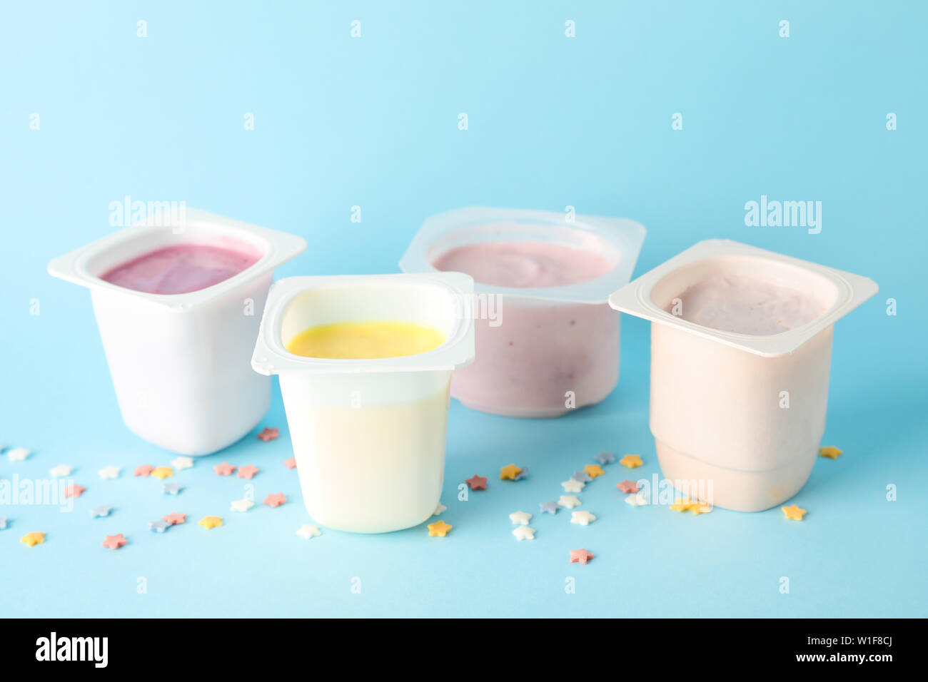 Download Plastic Cups With Yogurt And Small Stars On Color Background Space For Text Stock Photo Alamy Yellowimages Mockups
